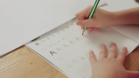 Little girl preparing her English homework