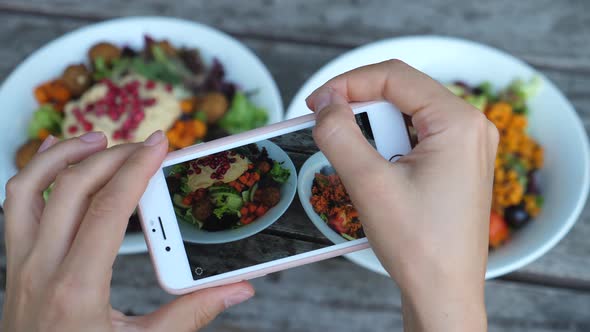 Close Up Of Hands Taking Photos Of Food In Cafe, Focus On Salad Bowls In Smartphone Screen