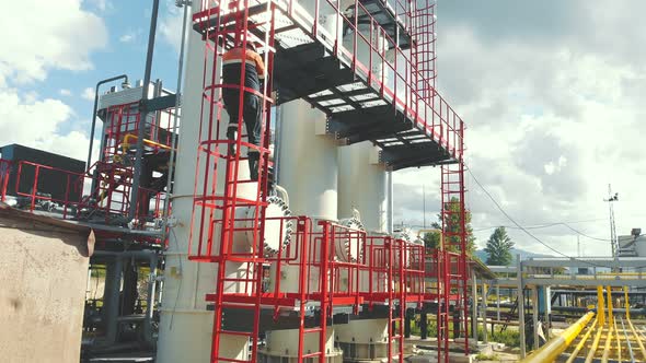 Aerial View Gas Station Operator Descends From the Top of the Station, Modern Gas Complex 