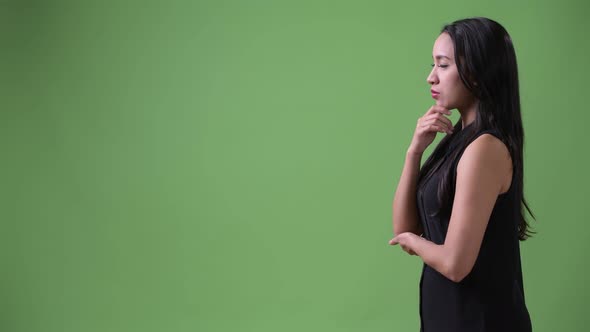 Profile View of Young Beautiful Asian Businesswoman Thinking