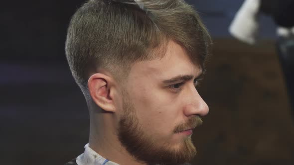 Handsome Yougn Man Getting a Haircut at the Barbershop