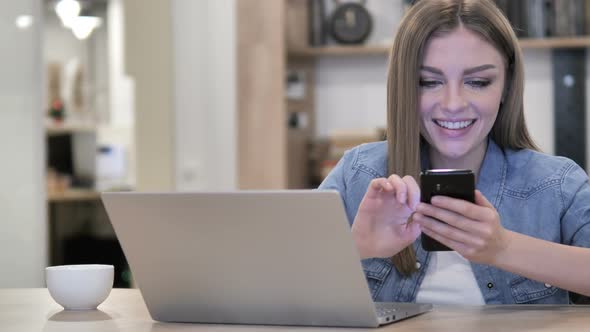 Creative Woman Browsing Internet and Using Smartphone