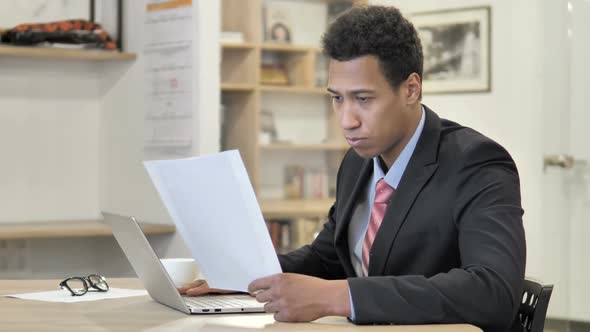 African Businessman Reading New Contract at Work