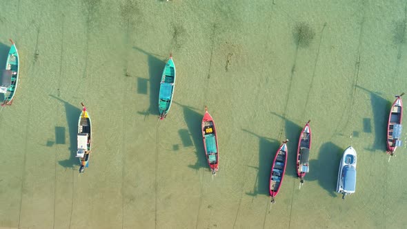 Amazing aerial Top view Longtail fishing boats in the tropical sea at Rawai beach Phuket Thailand