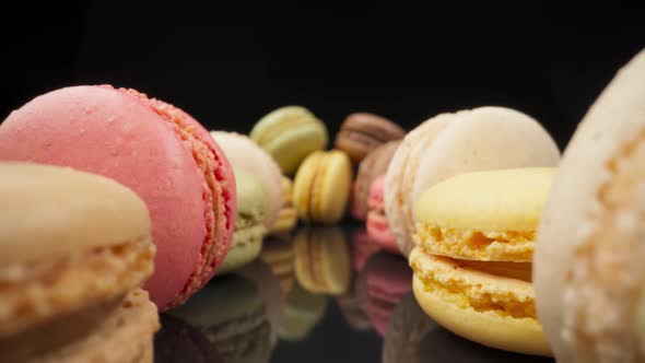 Colored Macaroons Confectionery Marshmallows on a Black Reflective Background in Perspective