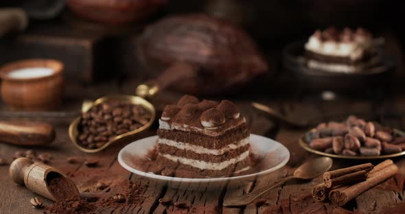 Tiramisu cake "falls" onto the table, lifting cocoa powder into the air.