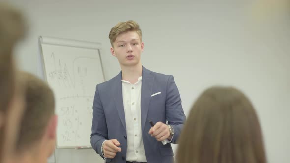 Confident Young Confident Businessman Presenting New Project To Partners with Flip Chart