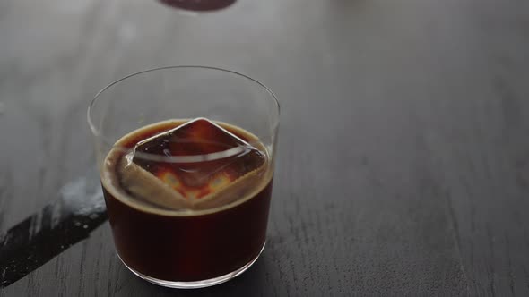 Slow Motion Making Espresso Tonic in Tumbler Glass Pour Tonic in Espresso with Ice