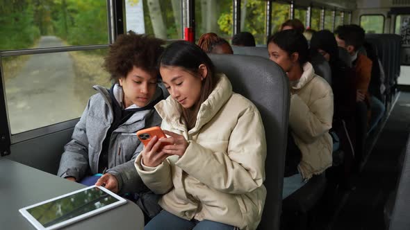 Multiracial Pupils Communicating Riding School Bus