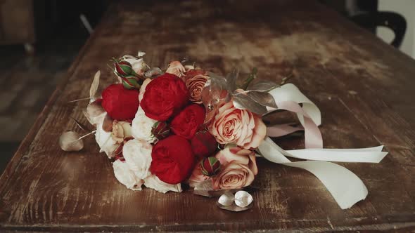 Beautiful Wedding Bouquet Decorated with Fresh Rose and Carnation Red Flowers and Green Leaves