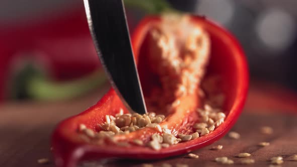 Slow Motion of Grains From Red Chilli Pepper with Knife