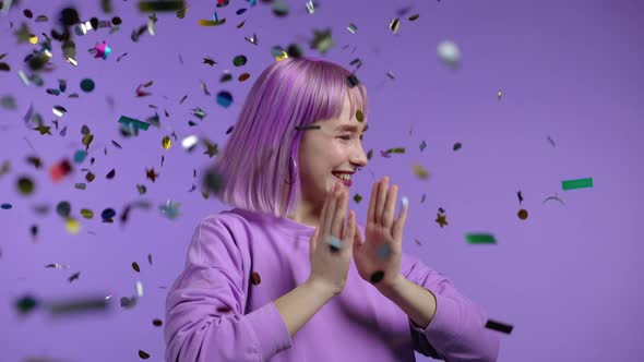 Excited Unique Woman Clapping Hands Having Fun Screaming WOW Rejoices Over Confetti Rain in Studio