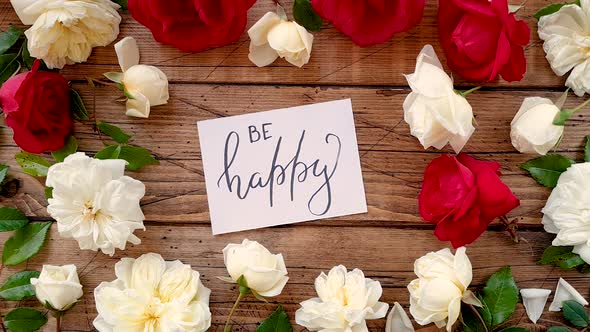 BE HAPPY card on a wooden table top view zoom in