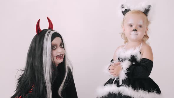 Kids in Halloween Costumes Pose in White Studio