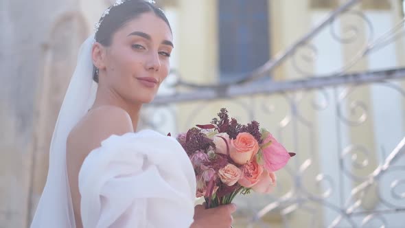 Bride Holds Beautiful Wedding Bouquet Before Her Face