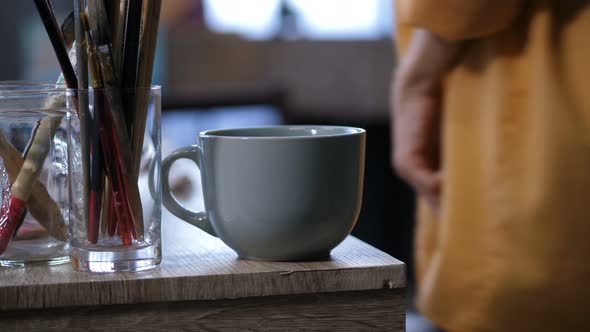 Coffee Cup and Artistic Equipment on Work Table