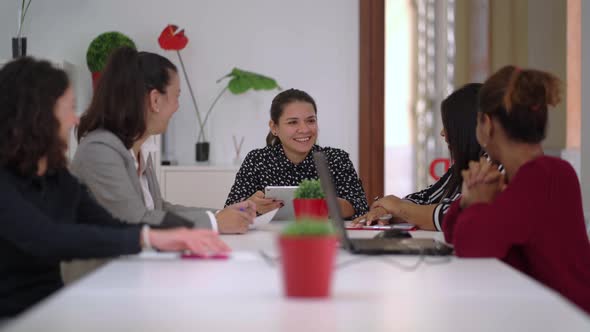 Group of diverse colleagues discussing work in conference room