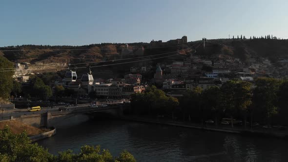 View of the Cable Car, on Which Rises the Cabin on the Background of the City of Tbilisi. Aerial