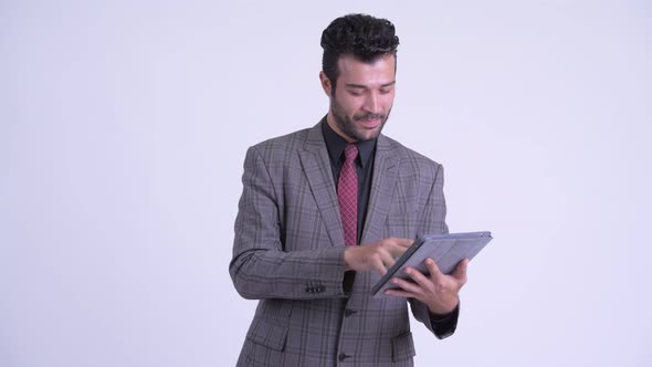 Happy Bearded Persian Businessman Thinking While Using Digital Tablet