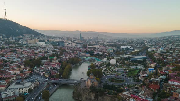 Aerial hyperlapse of beautiful cityscape of Tbilisi at sunset, Georgia