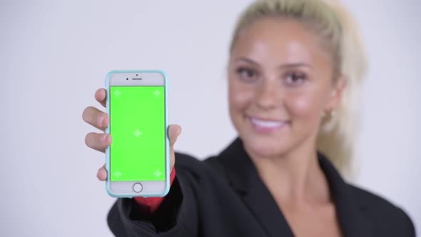 Face of Young Happy Blonde Businesswoman Showing Phone