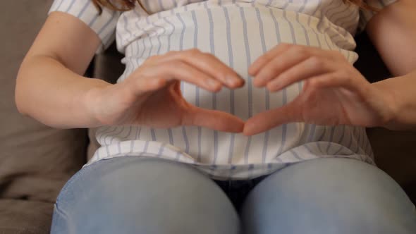Pregnant Woman Showing Hand Heart Gesture