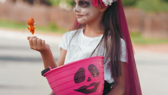 Ecstatic Girl in Halloween Costume Posing after Trick-or-Treating