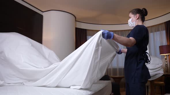 Hotel Employee Making Bed for New Guests