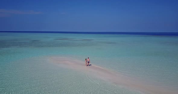 Young people after marriage in love spend quality time on beach on white sand background 