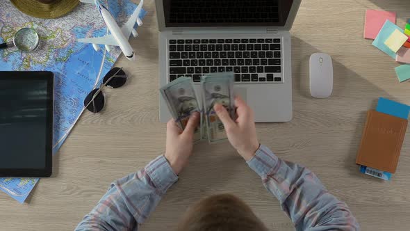 Rich Traveler Sitting at Table and Counting Money, Vacation Planning, Top View