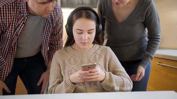 Teenage Girl Listening Music and Using Smartphone While Parent Shout and Argue with Her