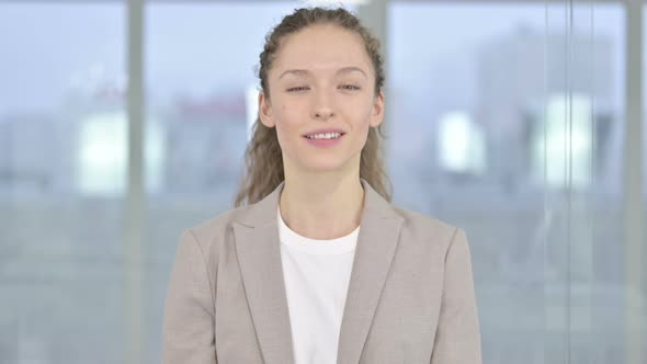 Portrait of Beautiful Young Businesswoman Saying Yes By Shaking Head