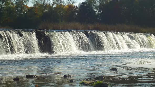 Venta river Rapid wide shot, the widest waterfall in Europe in sunny autumn day, located in Kuldiga