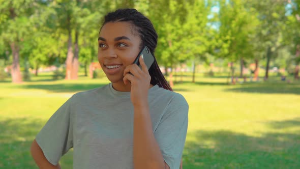 Casual Female Talking By Phone on the Street