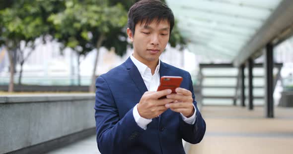 Businessman use of mobile phone at outdoor