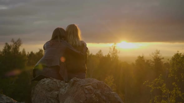 Two Women Are Looking on the Sunset