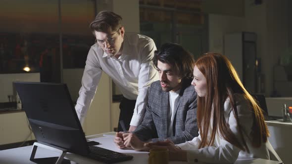 A Hardworking Woman Works Late at the Office with Colleagues