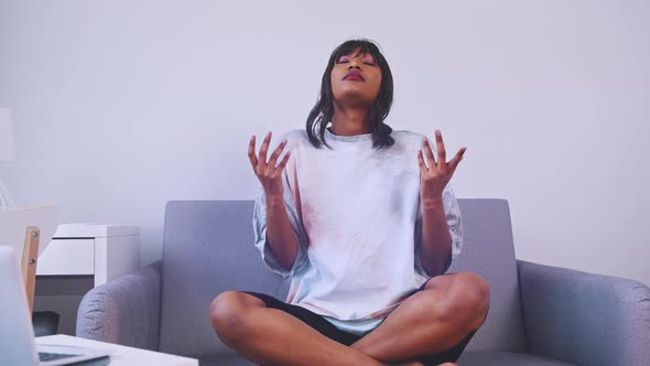 African American Woman Meditating on Her Couch