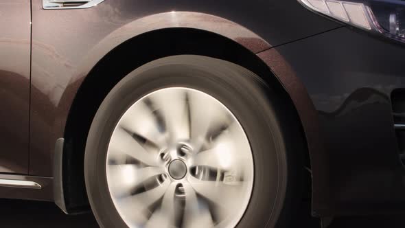 A Spinning Wheel Next to a Passing Car