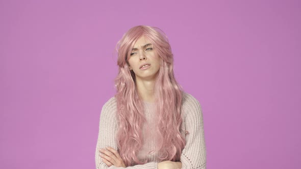 Impatient and Reluctant Young Bothered Cute European Teenage Girl in Pink Wig Cross Hands Over Chest