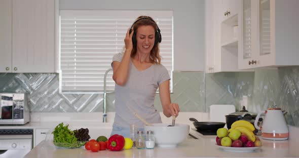 Portrait of Cheerful Woman Singing Song in Whisker on Dometic Kitchen in Slow Motion