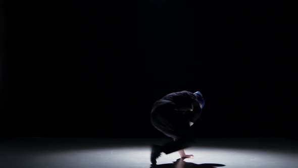 Boy in Blue Hat Dancing Breakdance, on Black, Shadow