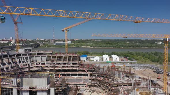 Future Sports Arena and Yellow Cranes on Riverbank Aerial