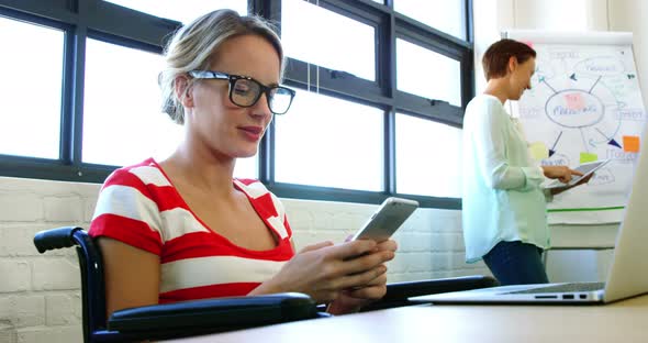 Female executive using mobile phone