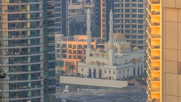Al Raheem Mosque Between Skyscrapers Timelapse on the Marina Walk in Dubai Marina Dubai UAE
