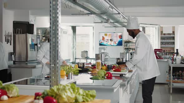 Man and Woman Cutting Fresh Ingredients to Make Gourmet Dish