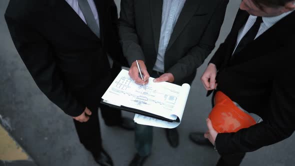 Business People Signing Architecture Documents