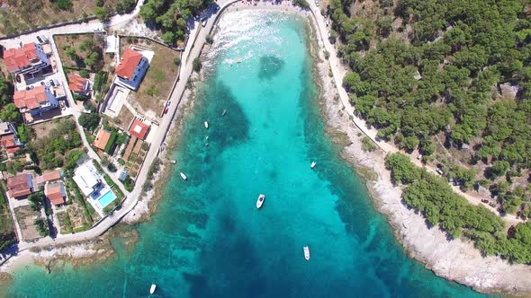 Aerial view of people swimming in turquoise bay on the island of Brac, Croatia