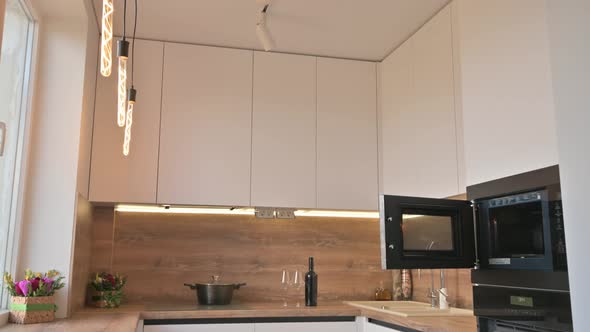 Wide Angle Tilt Shot of Modern White and Wooden Beige Kitchen Interior