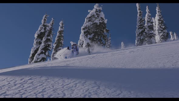 Downhill Skier Taking Quick Turn On Steep Run